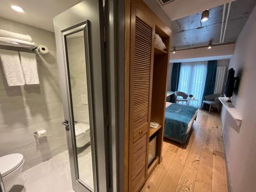 a bathroom with a toilet and a sink and a room at Royal Galata Hotel in Istanbul