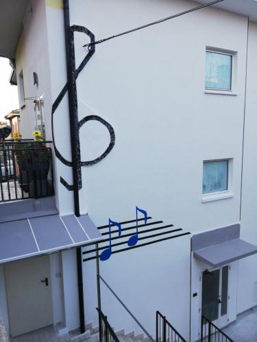 a metal sign on the side of a building at Sun in Nago-Torbole