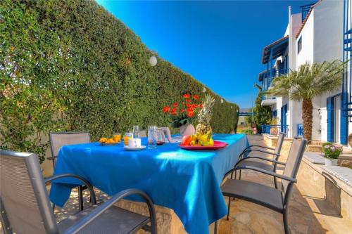 a table with a blue table cloth on a patio at Cretan Dawn Apart, Value Option in Ammoudara in Ayía Marína