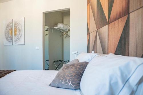 a bedroom with a white bed with a wooden headboard at Residenza del Sele in Foggia