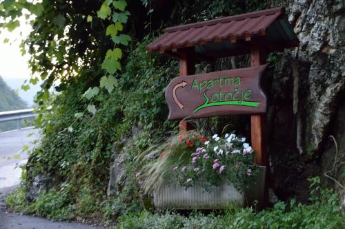 a sign for aqualung snooze on the side of a road at Apartment Sotočje in Dolenja Trebuša