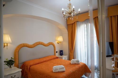 a bedroom with a bed with two towels on it at Villa Le Zagare Relais & SPA in Gragnano