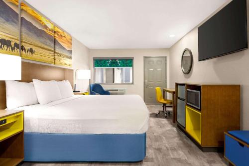 a hotel room with a bed and a desk at Days Inn by Wyndham Ruidoso Downs in Ruidoso Downs