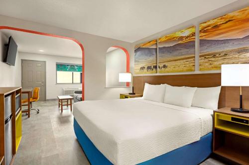 a hotel room with a bed and a desk at Days Inn by Wyndham Ruidoso Downs in Ruidoso Downs