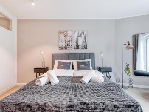 a bedroom with a large bed with three pillows at Limehome Münster Von-Steuben-Str - Digital Access in Münster