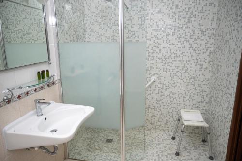 a bathroom with a sink and a glass shower at Villa Le Zagare Relais & SPA in Gragnano