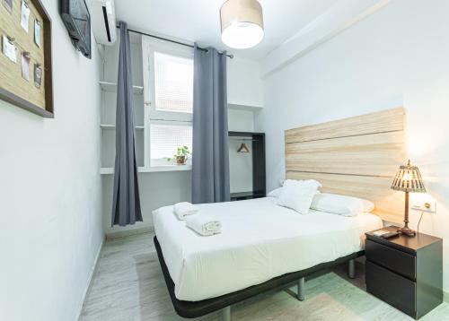 a hotel room with a large bed and a large window at Easy Sants by Bossh! in Barcelona