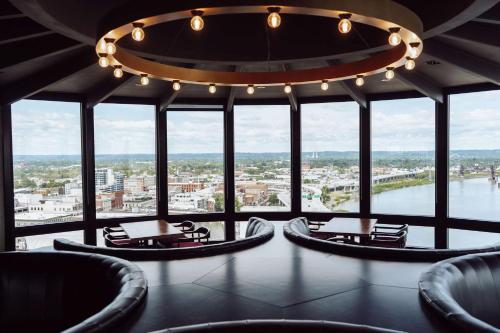 a large room with chairs and tables and a chandelier at Galt House Hotel, A Trademark Collection Hotel in Louisville