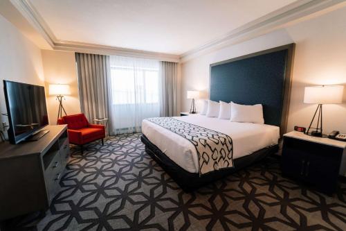 a hotel room with a bed and a television at Galt House Hotel, A Trademark Collection Hotel in Louisville
