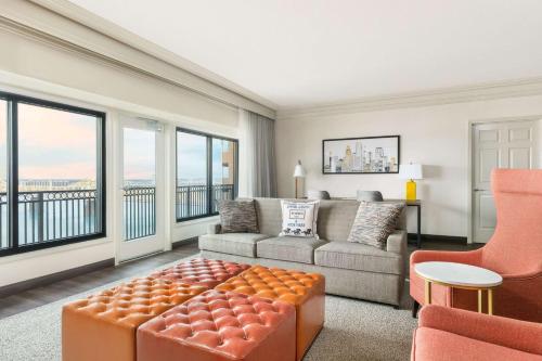 a living room with a couch and a chair at Galt House Hotel, A Trademark Collection Hotel in Louisville