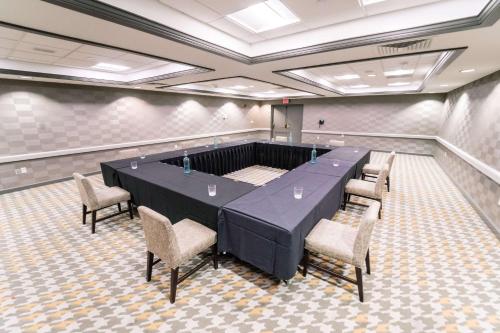 a conference room with a long table and chairs at Galt House Hotel, A Trademark Collection Hotel in Louisville