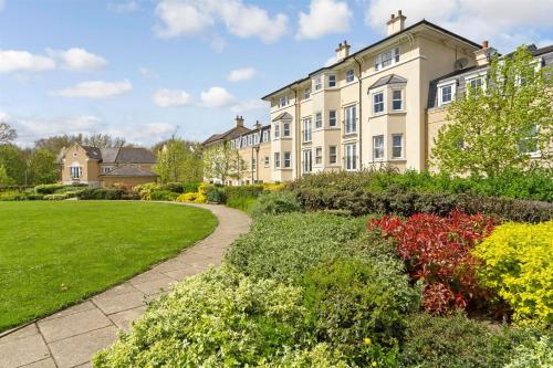 a large building with a garden in front of it at Mathus Gardens in Cambridge