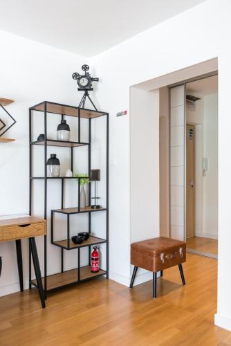 a room with a shelf and a table and a stool at Paparazzi Apartment in Split