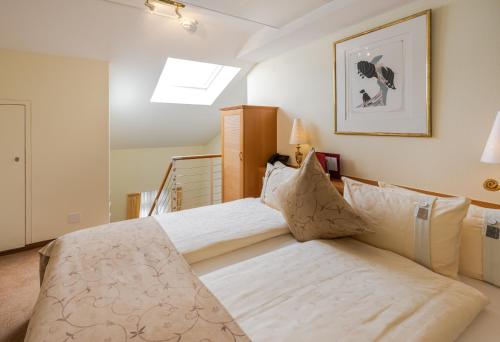 a bedroom with two beds and a skylight at GAIA Hotel Basel - the sustainable 4 star hotel in Basel