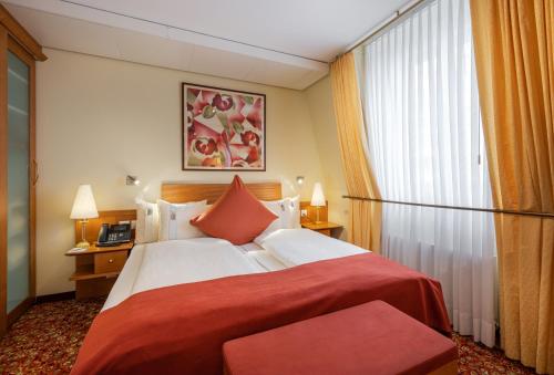 a hotel room with a large bed and a window at GAIA Hotel Basel - the sustainable 4 star hotel in Basel