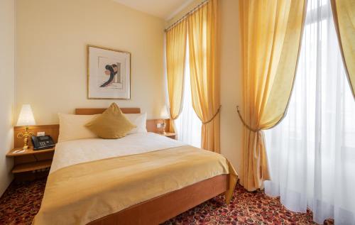 a bedroom with a bed and a large window at GAIA Hotel Basel - the sustainable 4 star hotel in Basel