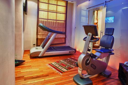 a gym with a treadmill and a exercise bike at Grand Hotel Wagner in Palermo