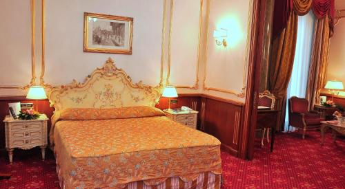 a hotel room with a bed and two night stands at Grand Hotel Wagner in Palermo
