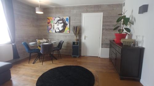 a dining room with a table and blue chairs at Coeur de ville, calme, spacieux,Parking et wifi ! in Chartres