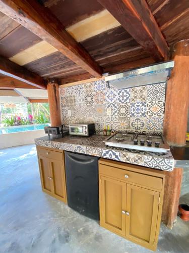 a kitchen with a stove and a counter top at Nuscaa Boutique Tree House & Spa in Puerto Morelos