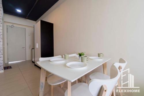 a white table and chairs in a room at 9am-5pm, SAME DAY CHECK IN AND CHECK OUT, Work from Home, Comfy & Quiet Tamarind Suites-Cyberjaya by Flexihome-MY, in Cyberjaya