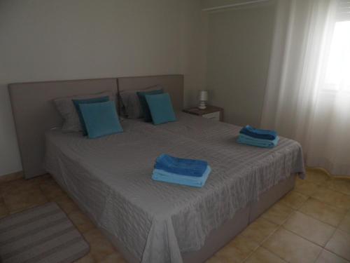 a bedroom with a bed with blue towels on it at 180° Sea View - Fabulosa vista mar! in Quarteira