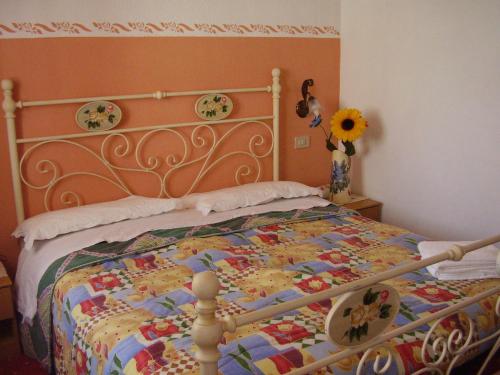 a bedroom with a bed with a quilt on it at Albergo Malga Ciapela in Rocca Pietore