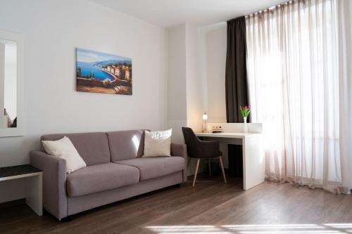a living room with a couch and a table at Hotel La Fleur in Überlingen