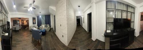 a large living room with a couch and a tv at Lovely and warming 3 bed in Morelia