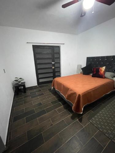 a bedroom with a bed and a ceiling fan at Lovely and warming 3 bed in Morelia