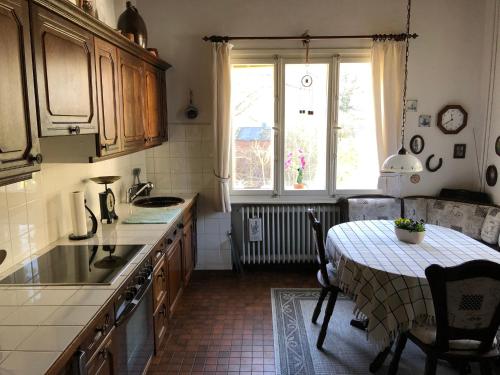 a kitchen with a table and a sink and a window at Ferienhaus Hudemühlen in Hodenhagen