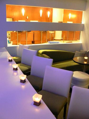 a waiting room with green and purple chairs and tables at Novotel Toronto North York in Toronto