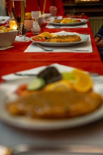 a red table with plates of food on it at Hotel Tiefenhagen Sauerland in Lennestadt