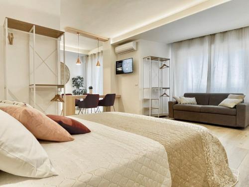 a bedroom with a large bed and a living room at Barirooms - Picca 24 in Bari
