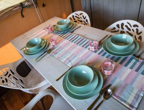 a table with plates and dishes on top of it at Buiten aan de Baak in Steenbergen