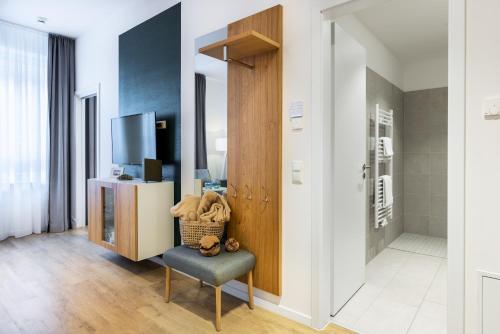 a living room with a chair and a tv at Ferienapartments am Krusespeicher Ferienapartments am Krusespeicher 2-20 in Wismar