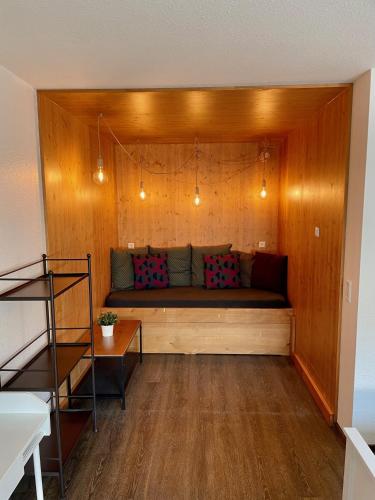 a living room with a couch in a wooden wall at Busses Guesthouse in Freiburg im Breisgau