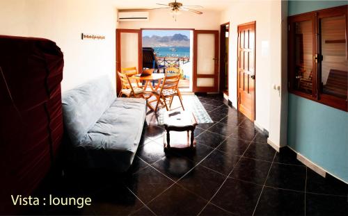 a living room with a couch and a table at Solar Windelo in Mindelo