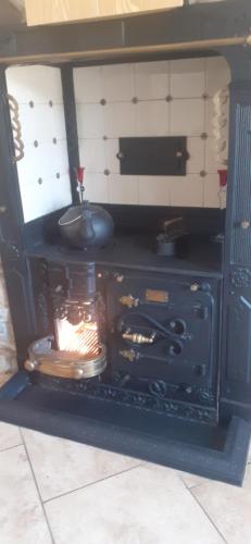 an old stove with a pot on top of it at Penbetha House B&B in Truro