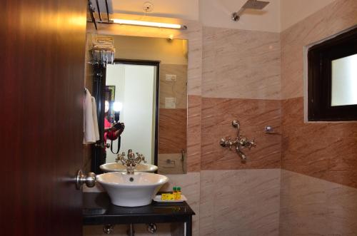 a bathroom with a sink and a mirror at Raj Regency in Jaipur