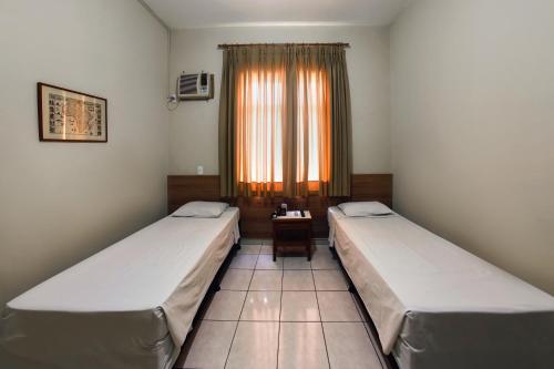 Säng eller sängar i ett rum på Hotel Itamarati