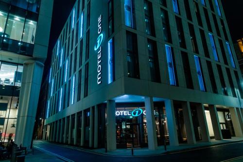 a large building with a clock on the front of it at Motel One Manchester-St. Peter´s Square in Manchester