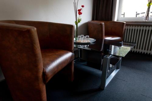 a waiting room with two chairs and a table at Hotel Tiefenhagen Sauerland in Lennestadt