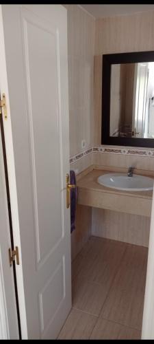 a bathroom with a sink and a mirror at Cozy Room with sunny terrace in Marbella