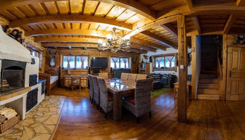 a dining room and living room in a log cabin at Drevenica Pod Vŕškom in Terchová