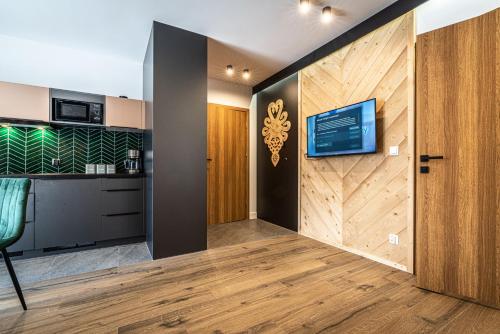 a room with a sliding door with a tv on a wall at Willa Trawers in Zakopane