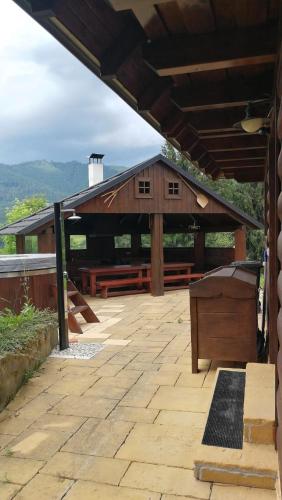 a large wooden building with a wooden piano on a patio at Drevenica Pod Vŕškom in Terchová