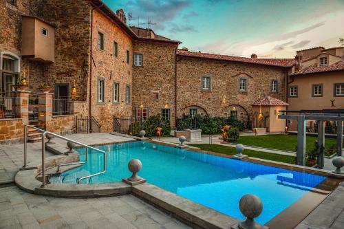 a swimming pool in front of a building at Monastero Di Cortona Hotel & Spa in Cortona