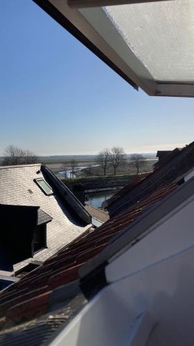 Cette chambre offre une vue sur le toit d'une maison dotée d'une fenêtre. dans l'établissement Superbe Studio en Plein Centre Ville, à Saint-Valery-sur-Somme