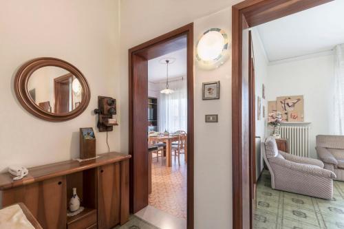 a hallway with a mirror and a dining room at La Maison de Mely with garden in Sandra